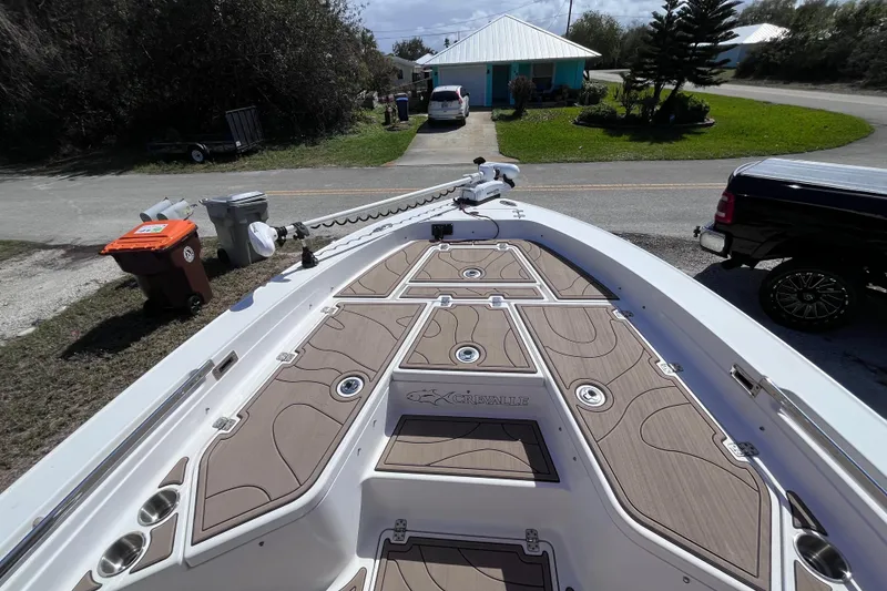 Slide: The Image of 2016 Crevalle 26 Bay boat with sleek deck design, parked in residential area. - 34