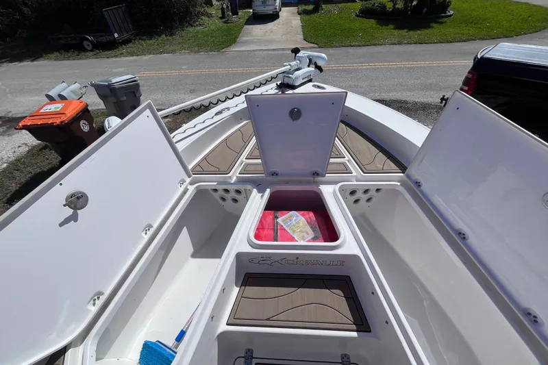 Slide: The Image of 2016 Crevalle 26 Bay boat with open storage compartments and visible deck details. - 37