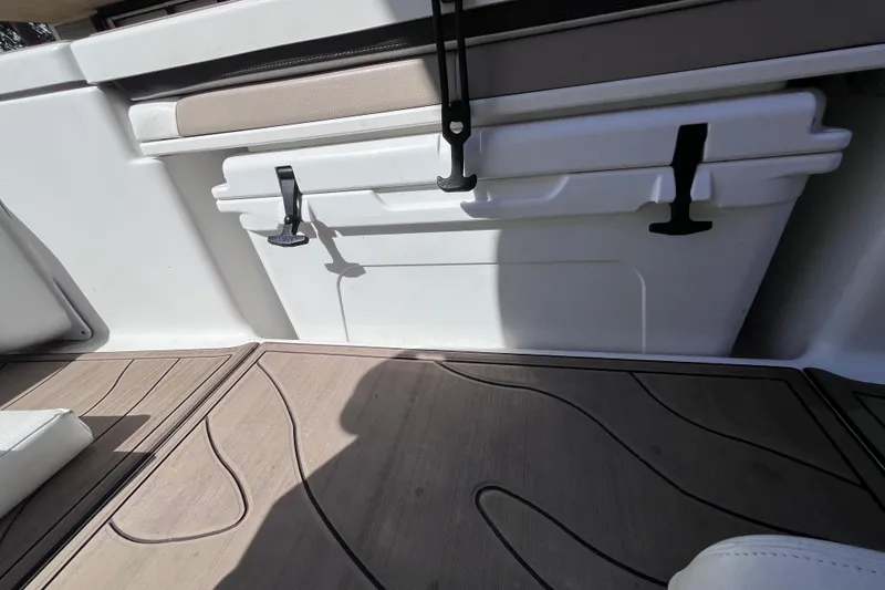 Slide: The Image of 2016 Crevalle 26 Bay boat interior with storage compartment and cushioned seating. - 41