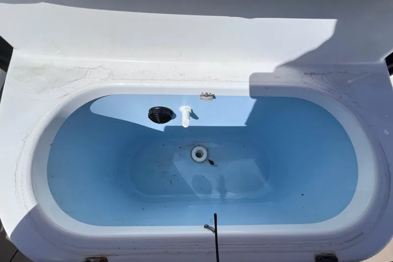 Slide: The Image of Livewell in 2016 Crevalle 26 Bay boat, featuring a clean, blue interior. - 43