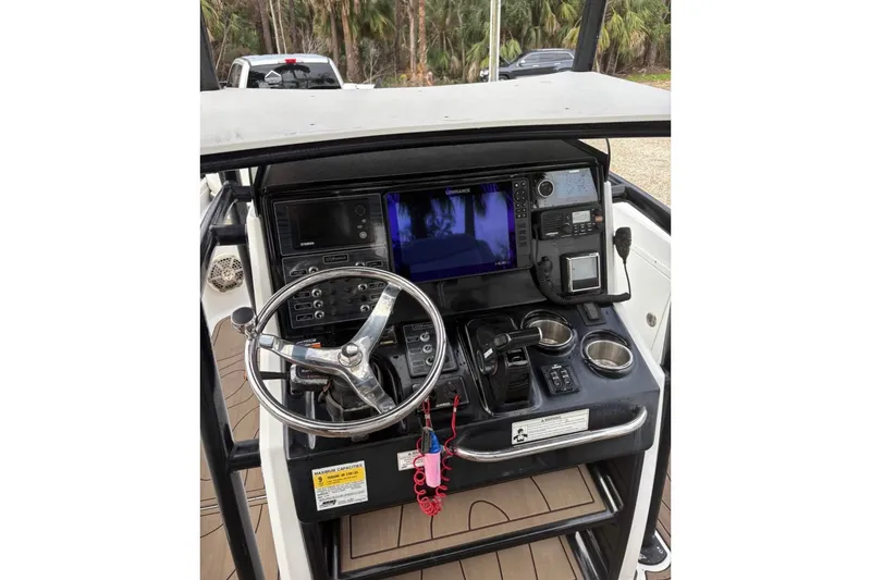 Slide: The Image of 2016 Crevalle 26 Bay boat with Yamaha 300 engine, parked on gravel. - 5