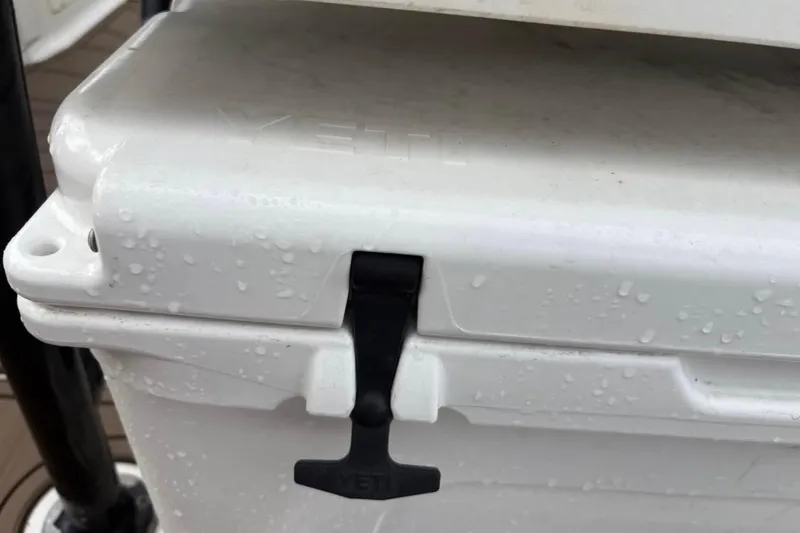 Slide: The Image of 2016 Crevalle 26 Bay boat with T-top, parked outdoors under blue sky. - 8