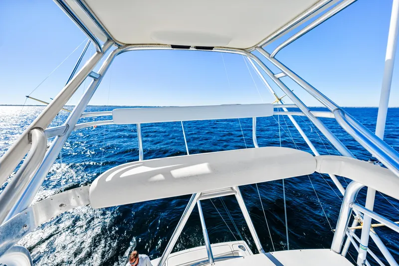 Slide: The Image of 2002 Pursuit 3800 Express boat on open sea, showcasing helm and ocean view. - 14