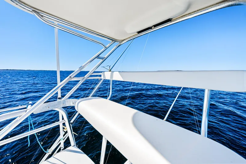 Slide: The Image of 2002 Pursuit 3800 Express boat on open water, clear blue sky. - 15