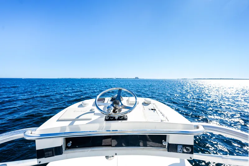 Slide: The Image of 2002 Pursuit 3800 Express boat on open sea under clear blue sky. - 16