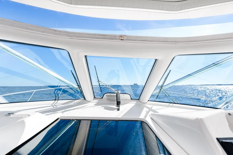 Slide: The Image of Interior view of 2002 Pursuit 3800 Express boat with ocean horizon through windows. - 17