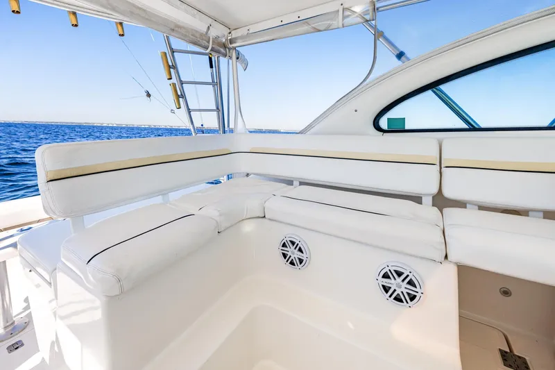 Slide: The Image of 2002 Pursuit 3800 Express boat interior with white seating and ocean view. - 20