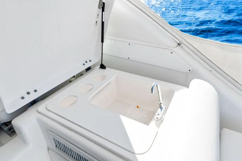 Slide: The Image of 2002 Pursuit 3800 Express boat sink area with ocean view. - 25
