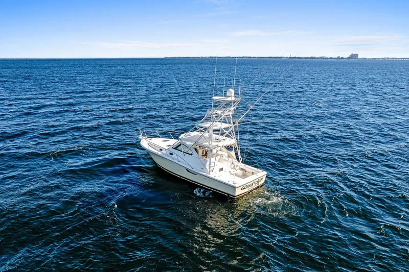 Slide: The Image of 2002 Pursuit 3800 Express boat cruising on open blue ocean waters. - 28