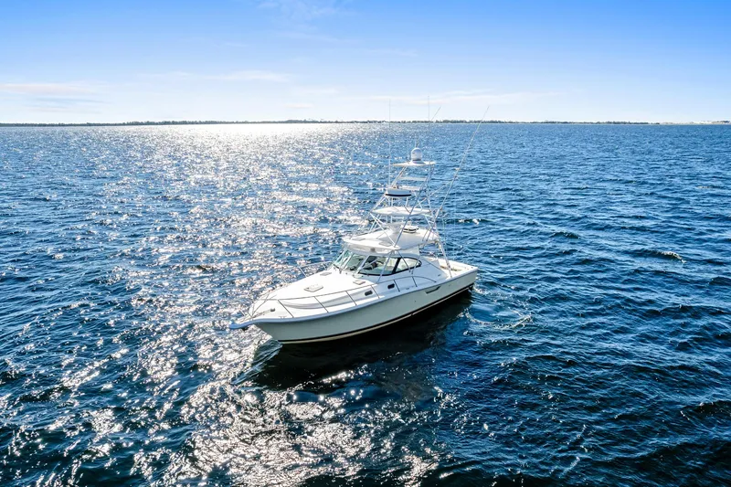 Slide: The Image of 2002 Pursuit 3800 Express boat cruising on open blue water. - 29