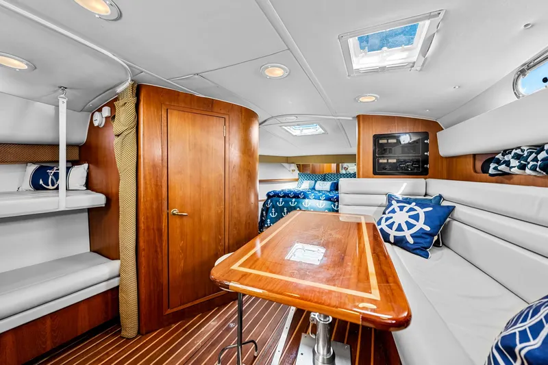 Slide: The Image of Luxurious interior of 2002 Pursuit 3800 Express yacht with wood accents and nautical decor. - 33