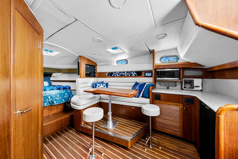 Slide: The Image of Luxurious 2002 Pursuit 3800 Express yacht interior with wood finishes and modern amenities. - 41