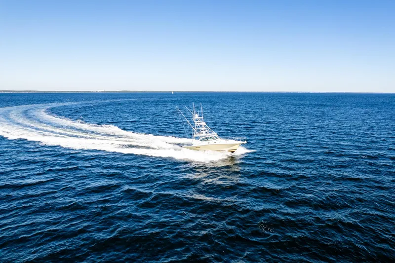 Slide: The Image of 2002 Pursuit 3800 Express boat cruising on open blue ocean. - 5