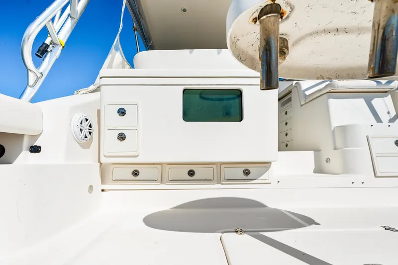 Slide: The Image of 2002 Pursuit 3800 Express boat interior with storage drawers and seating. - 6