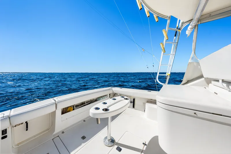 Slide: The Image of 2002 Pursuit 3800 Express boat deck with ocean view and fishing equipment. - 9