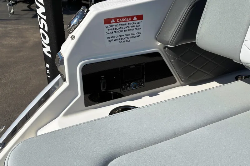 Slide: The Image of 2025 Chaparral 267 SSX boat interior with warning label and control panel. - 16
