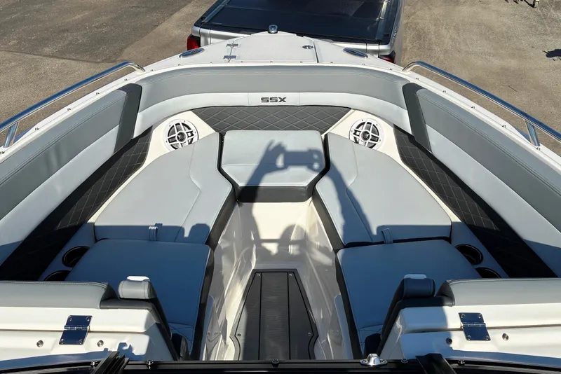 Slide: The Image of 2025 Chaparral 267 SSX boat interior with gray seating and modern design. - 18