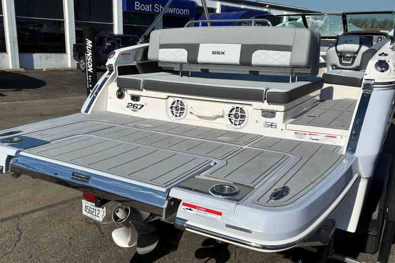 Slide: The Image of 2025 Chaparral 267 SSX boat rear view with spacious deck and seating. - 5
