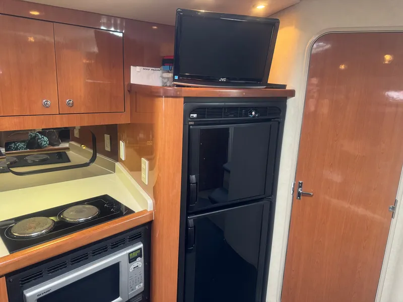 Slide: The Image of Interior of 1998 Cruisers Yachts 3870 Espirit with kitchen and TV. - 18