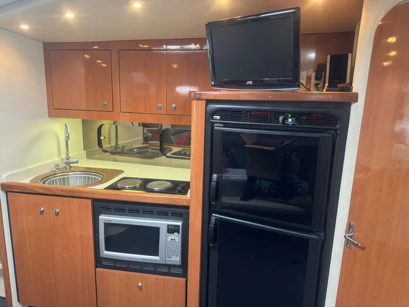 Slide: The Image of 1998 Cruisers Yachts 3870 Espirit kitchen area with appliances. - 19