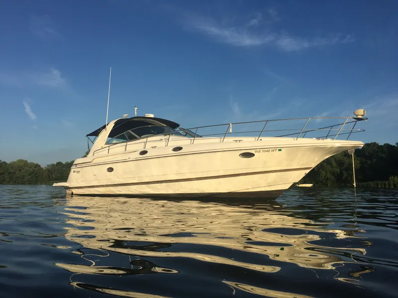 Slide: The Image of 1998 Cruisers Yachts 3870 Espirit on calm water at sunset. - 2