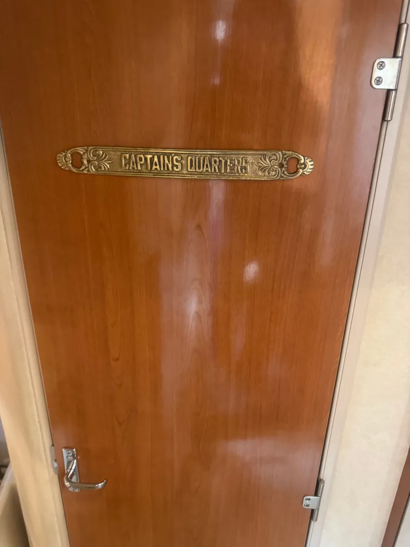 Slide: The Image of Wooden door with 'Captain's Quarters' sign on 1998 Cruisers Yachts 3870 Espirit. - 23