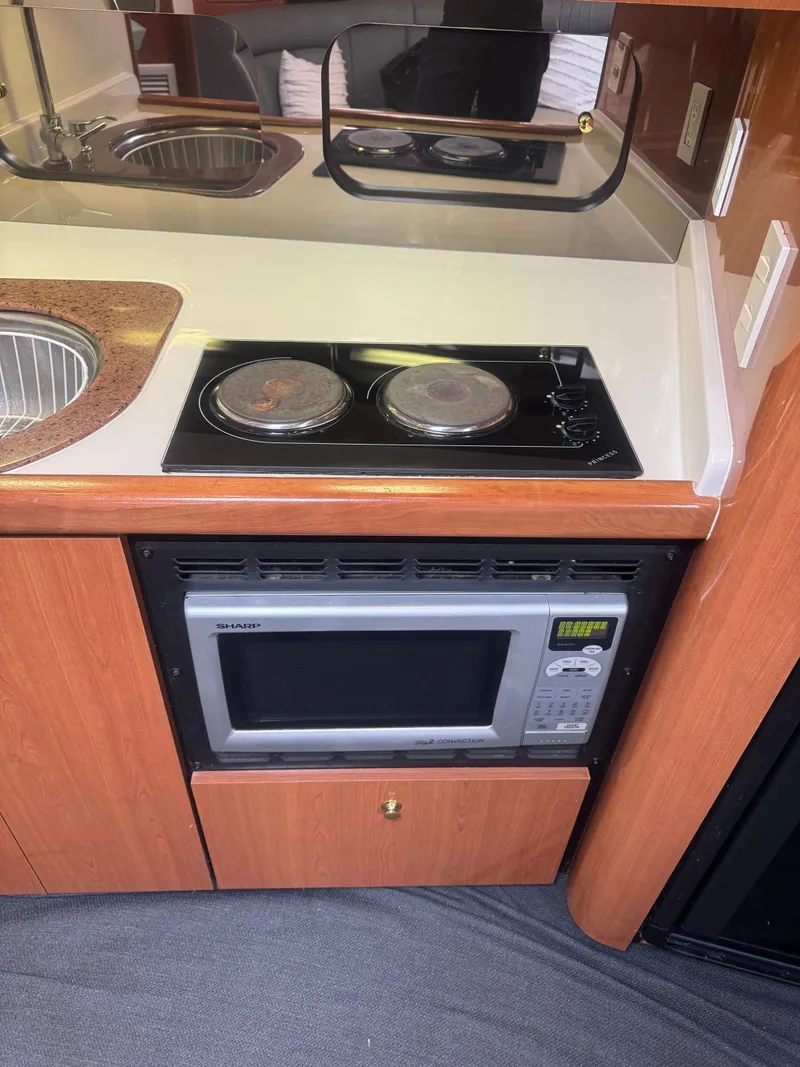 Slide: The Image of Kitchen area in a 1998 Cruisers Yachts 3870 Espirit with stove and microwave. - 26