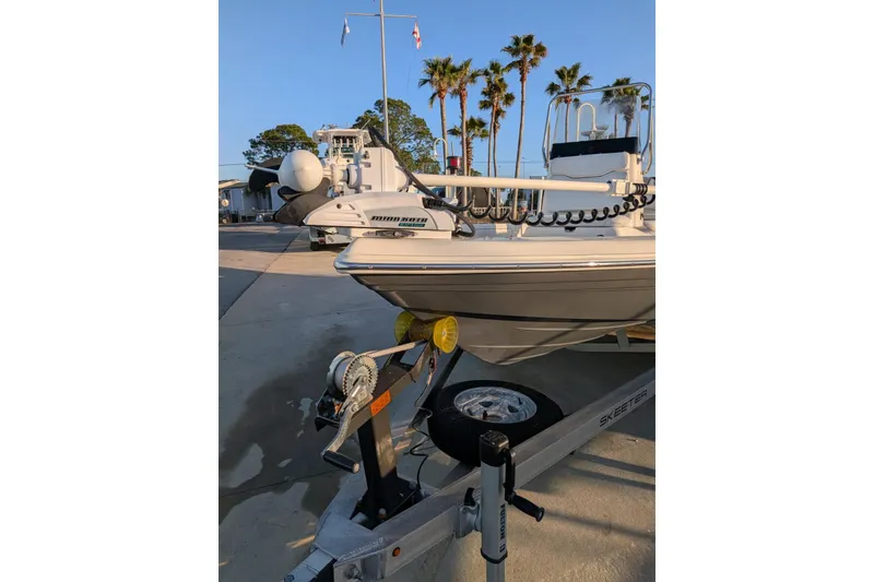 Slide: The Image of 2017 Skeeter SX200 boat on trailer with palm trees in background. - 3