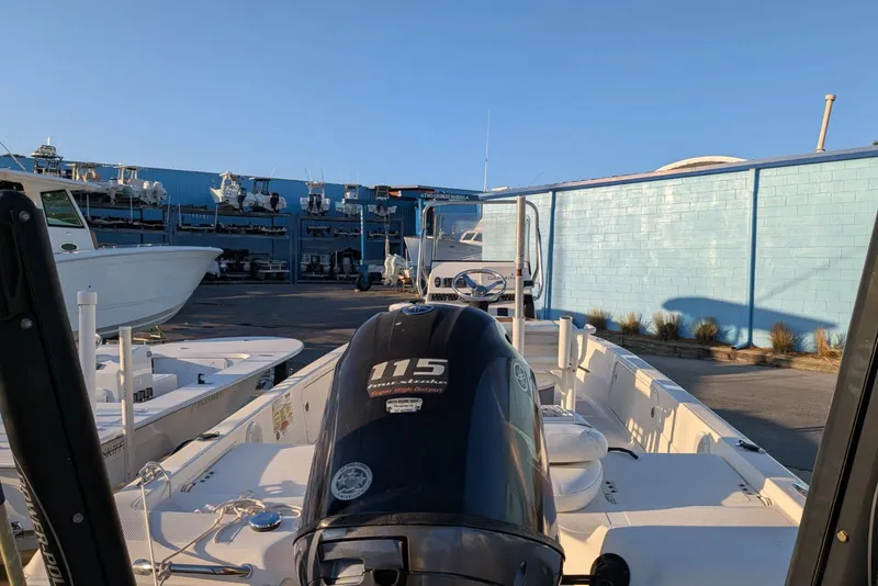 Slide: The Image of 2017 Skeeter SX200 boat with 115 horsepower engine in a marina setting. - 5