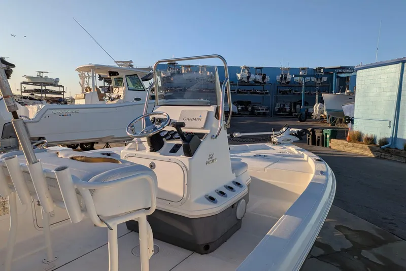 Slide: The Image of 2017 Skeeter SX200 boat with Garmin system, docked in a marina under clear skies. - 8