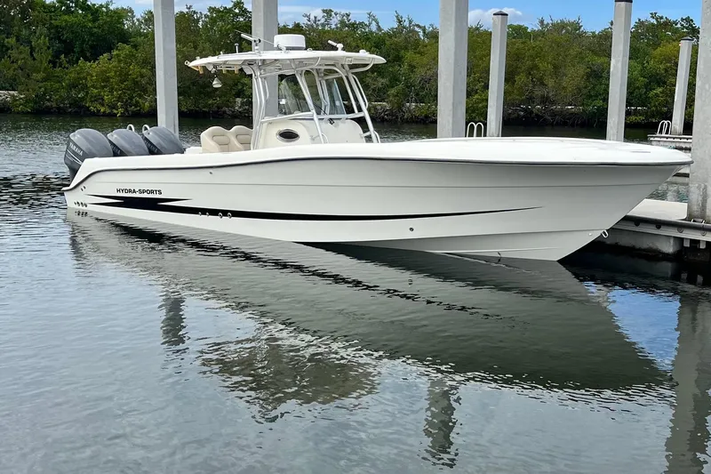 The Image of 2006 Hydra-Sports Vector 3300 CC boat docked, featuring sleek design and triple Yamaha engines. - 1