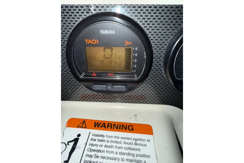 Slide: The Image of Yamaha tachometer on 2006 Hydra-Sports Vector 3300 CC boat dashboard with warning label. - 10