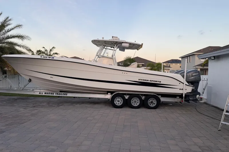 Slide: The Image of 2006 Hydra-Sports Vector 3300 CC boat on trailer, parked in residential driveway. - 3