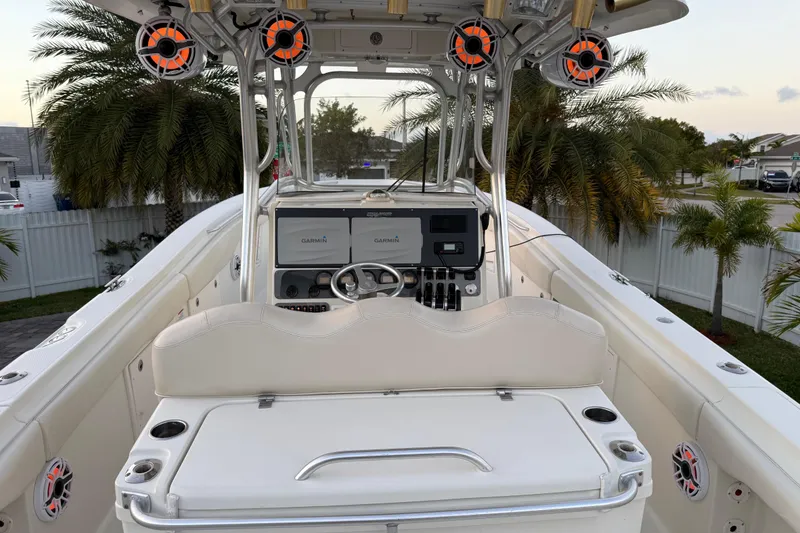 Slide: The Image of 2006 Hydra-Sports Vector 3300 CC boat interior with Garmin navigation, palm trees in background. - 7