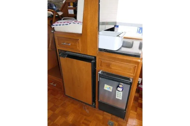 Slide: The Image of 1986 Ocean Alexander 39 Sedan interior with wooden cabinetry and compact appliances. - 11