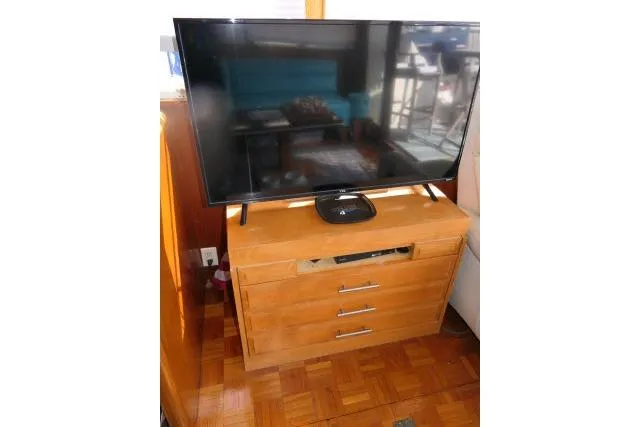 Slide: The Image of Flat-screen TV on wooden cabinet inside 1986 Ocean Alexander 39 Sedan yacht. - 12