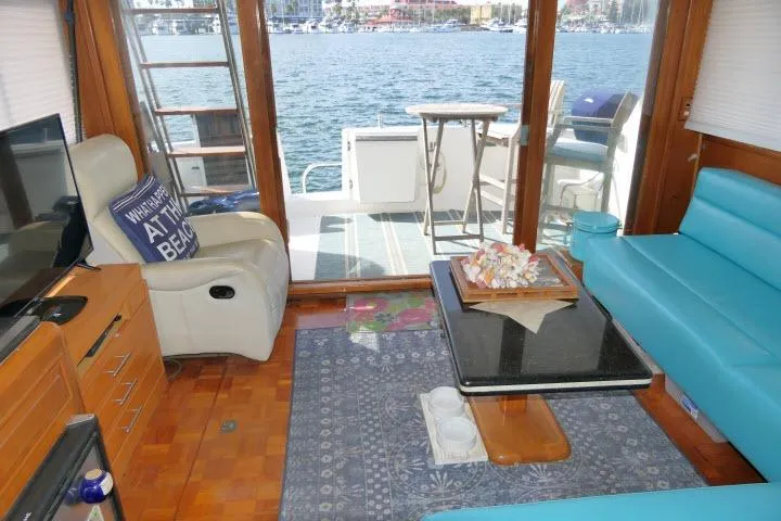 Slide: The Image of Interior of 1986 Ocean Alexander 39 Sedan yacht with blue seating and waterfront view. - 13