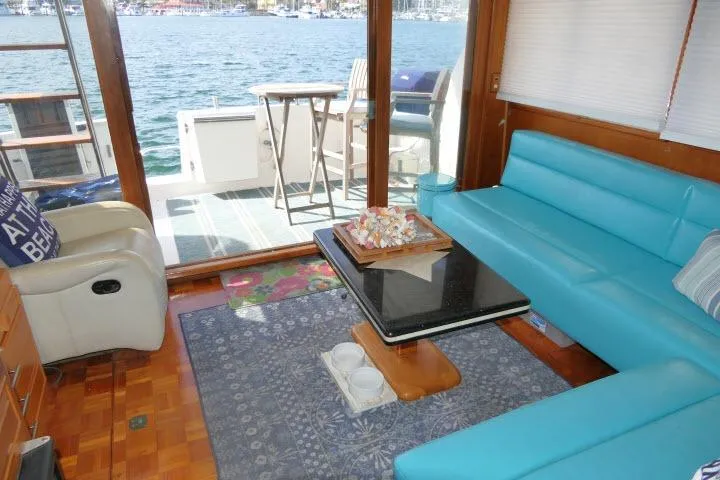 Slide: The Image of Interior of 1986 Ocean Alexander 39 Sedan with blue seating and waterfront view. - 15