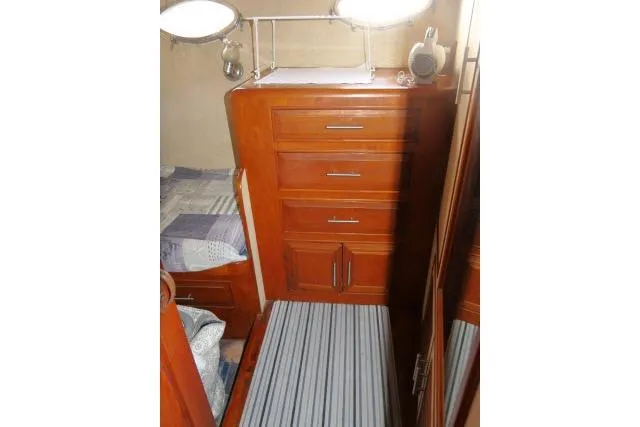 Slide: The Image of 1986 Ocean Alexander 39 Sedan interior with wooden cabinetry and striped carpet. - 21