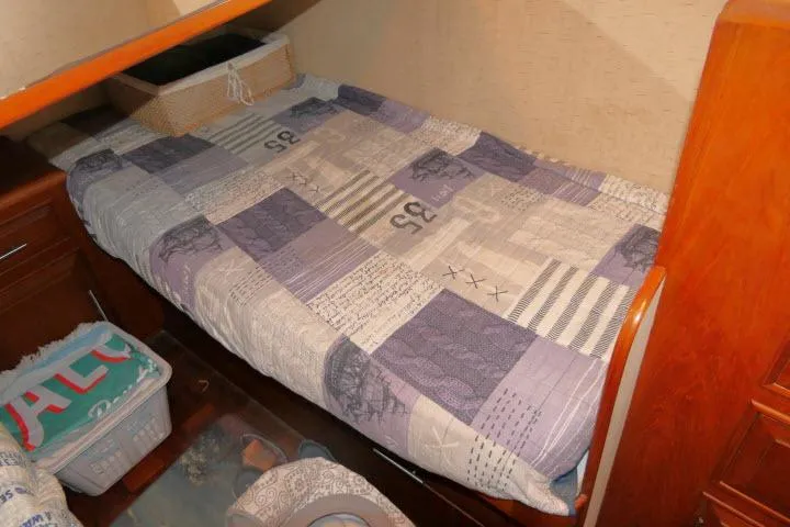 Slide: The Image of Cozy cabin bed in 1986 Ocean Alexander 39 Sedan yacht with patchwork quilt. - 25