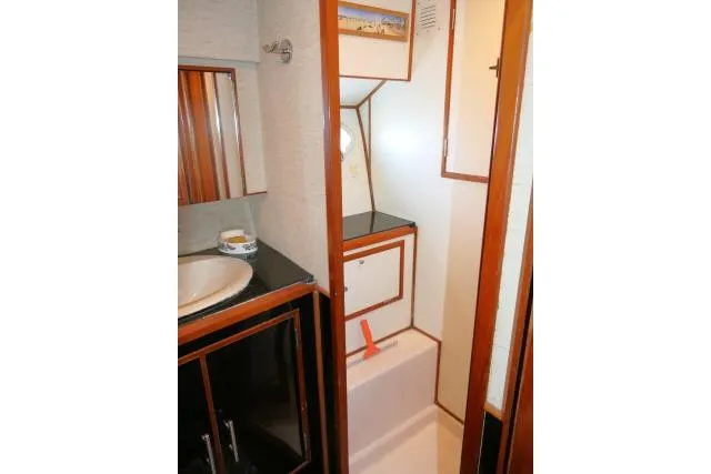 Slide: The Image of Bathroom interior of 1986 Ocean Alexander 39 Sedan yacht, featuring wood accents and compact design. - 29