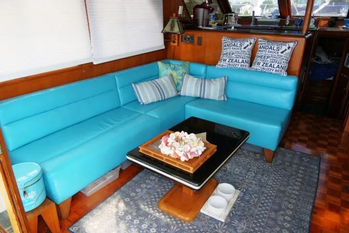 Slide: The Image of Interior of 1986 Ocean Alexander 39 Sedan with turquoise seating and decorative pillows. - 3