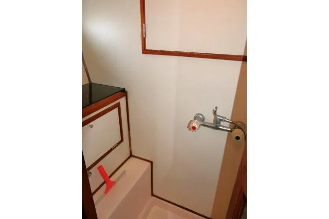 Slide: The Image of 1986 Ocean Alexander 39 Sedan bathroom with wooden trim and compact sink. - 30
