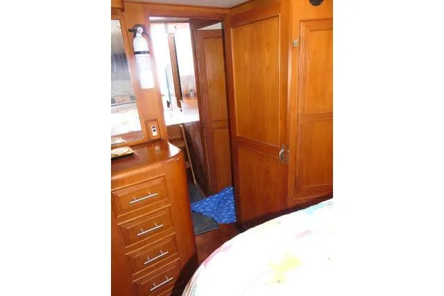 Slide: The Image of Interior of 1986 Ocean Alexander 39 Sedan with wooden cabinetry and drawers. - 32