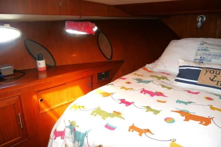 Slide: The Image of Cozy cabin interior of 1986 Ocean Alexander 39 Sedan with colorful bedding and wooden cabinetry. - 33