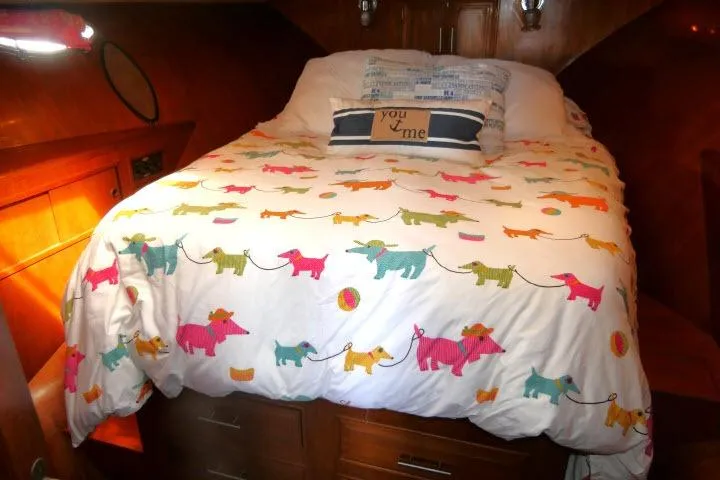 Slide: The Image of Cozy bedroom in 1986 Ocean Alexander 39 Sedan with colorful dog-themed bedding. - 34