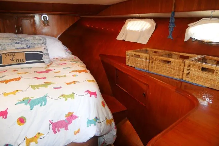 Slide: The Image of Cozy cabin interior of 1986 Ocean Alexander 39 Sedan with colorful bedding and wicker baskets. - 35
