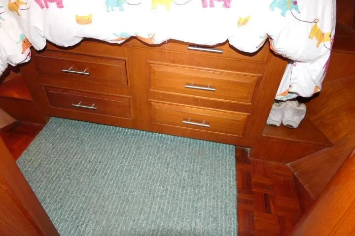 Slide: The Image of Interior of 1986 Ocean Alexander 39 Sedan with wooden drawers and colorful bedding. - 37