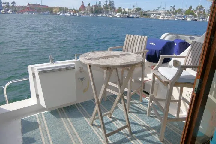 Slide: The Image of 1986 Ocean Alexander 39 Sedan yacht deck with chairs and table overlooking marina. - 41
