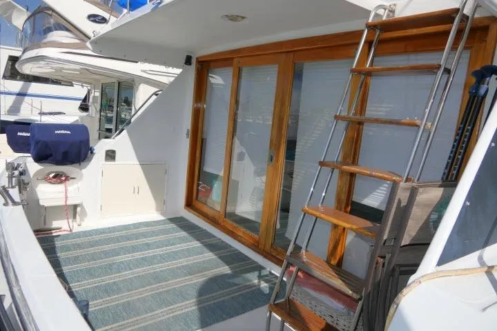 Slide: The Image of 1986 Ocean Alexander 39 Sedan yacht with wooden sliding doors and exterior ladder. - 44
